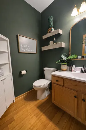 a bathroom with a toilet sink and mirror