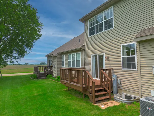 a view of a house with a yard and a deck