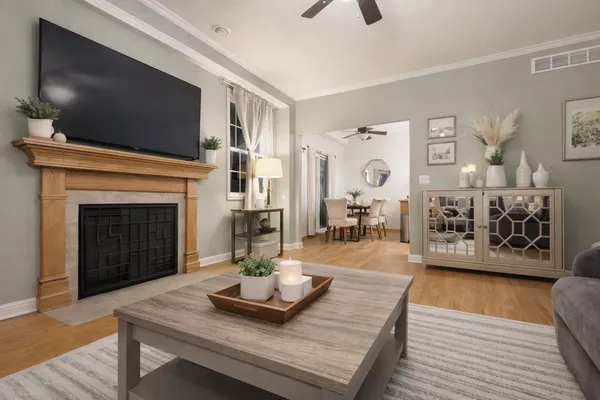 a living room with furniture a flat screen tv and a fireplace