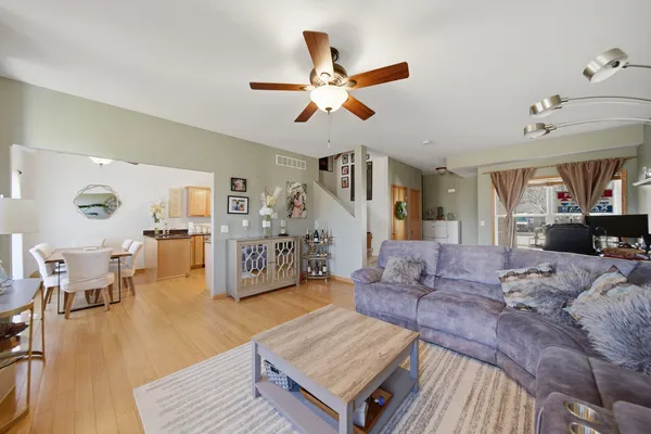 a living room with furniture and wooden floor