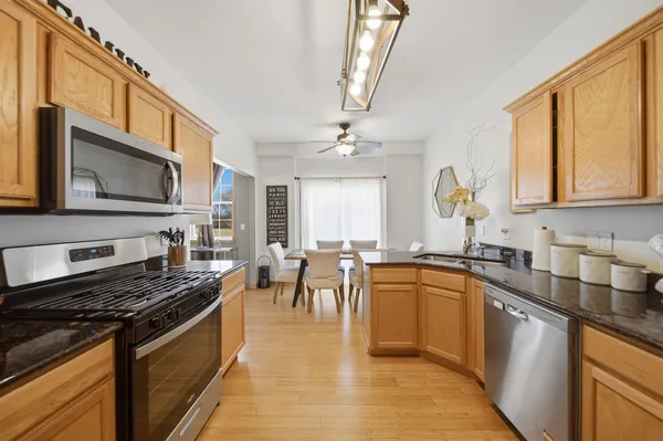 a kitchen with stainless steel appliances a stove sink microwave and cabinets