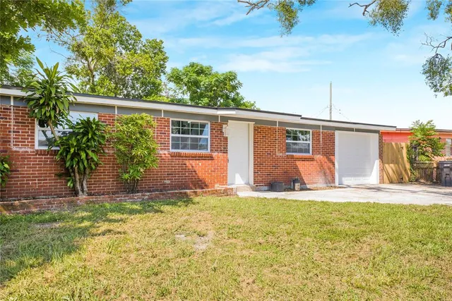 a house that has a big yard with plants