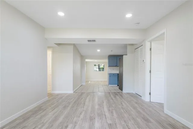 a view of a big room with wooden floor and a window