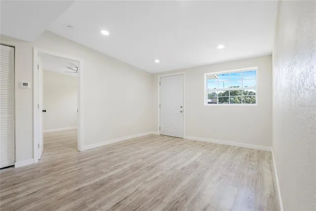 wooden floor in an empty room with a window