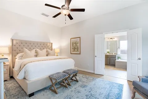 a bedroom with a bed and a chandelier