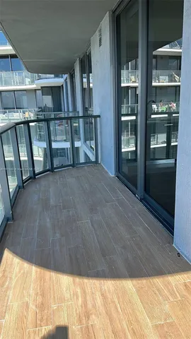 a view of staircase with white walls and wooden floor