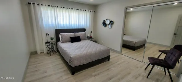 a bedroom with a bed and a chair