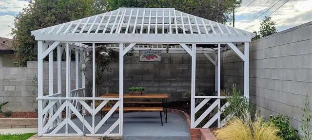 a front view of a house with balcony and furniture