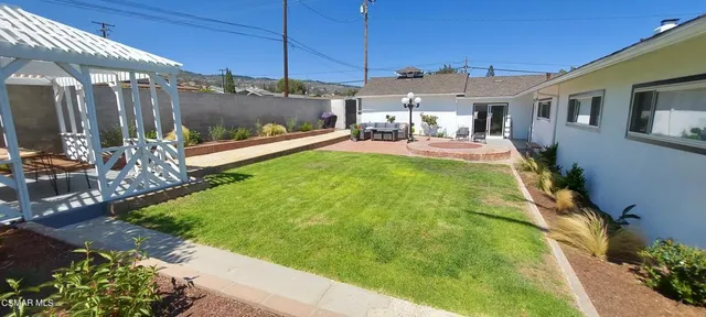 a view of a backyard with sitting area
