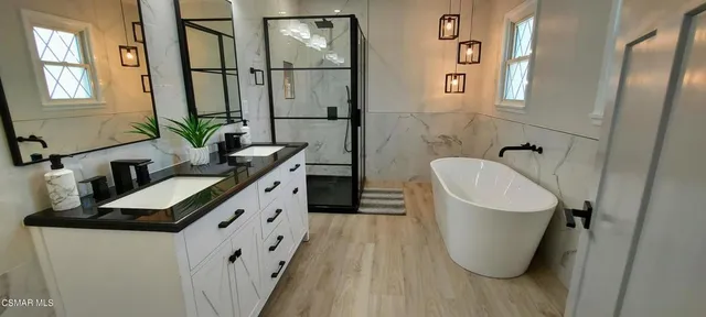 a bathroom with a granite countertop sink a toilet and shower