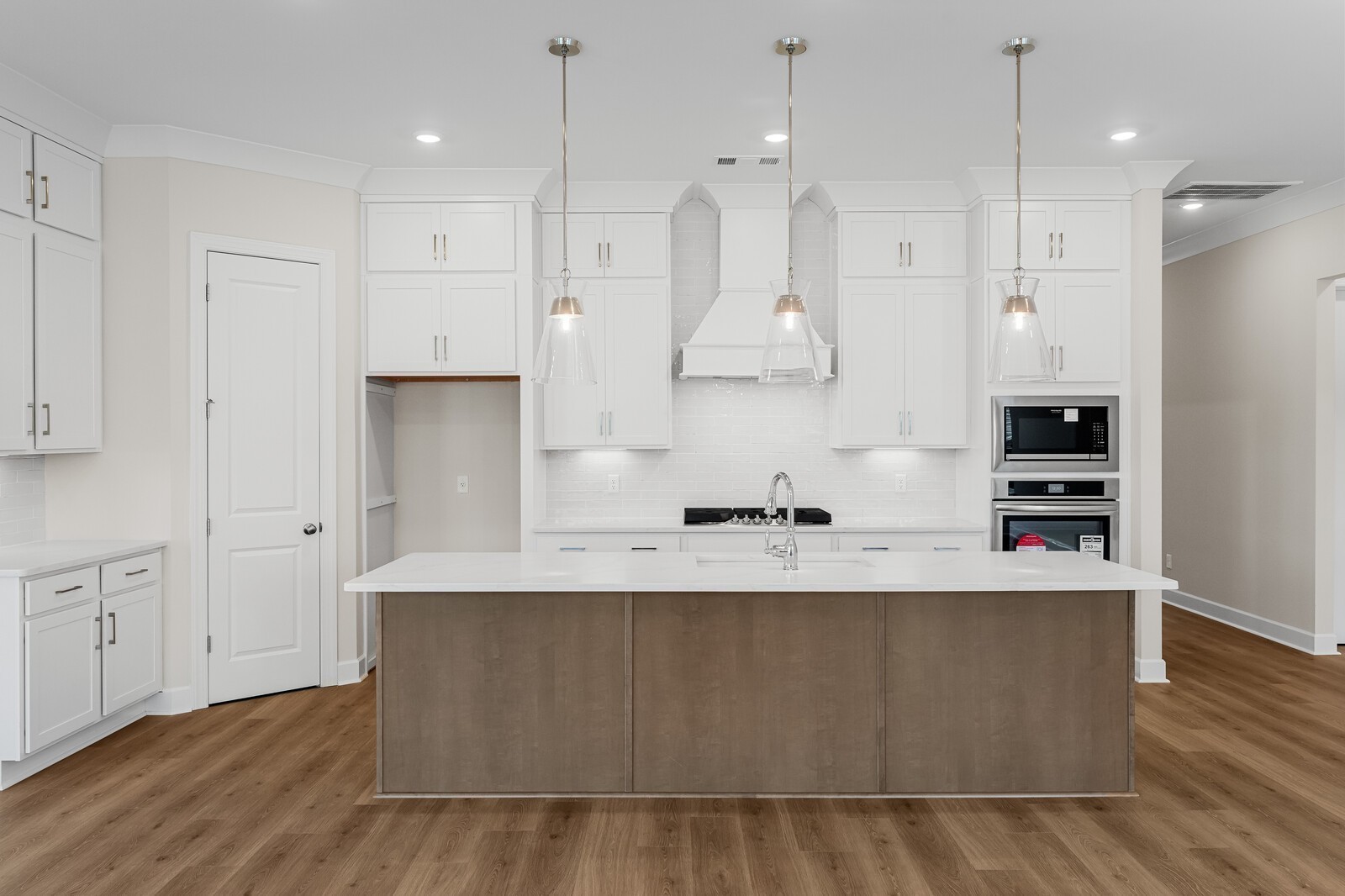 7456 Atwater Circle Fairview, TN 37062 - Photo 16 of 49 a large kitchen with stainless steel appliances a large counter top a stove a sink and a refrigerator