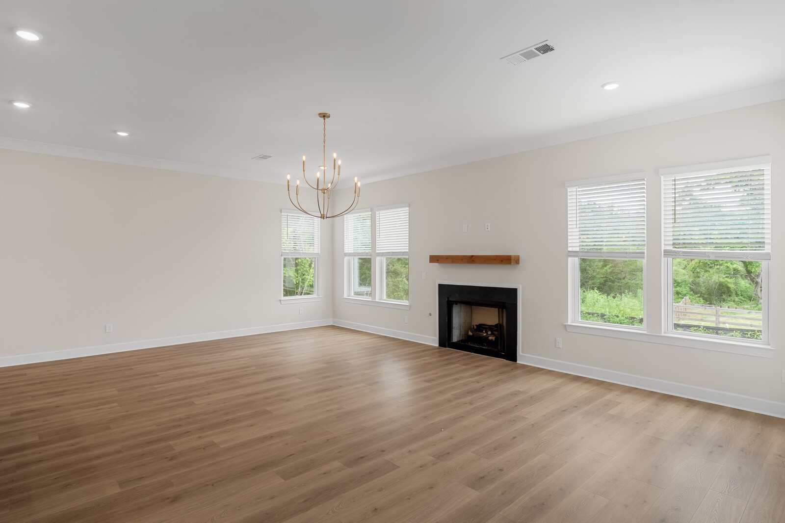 7456 Atwater Circle Fairview, TN 37062 - Photo 20 of 49 an empty room with wooden floor fireplace and windows