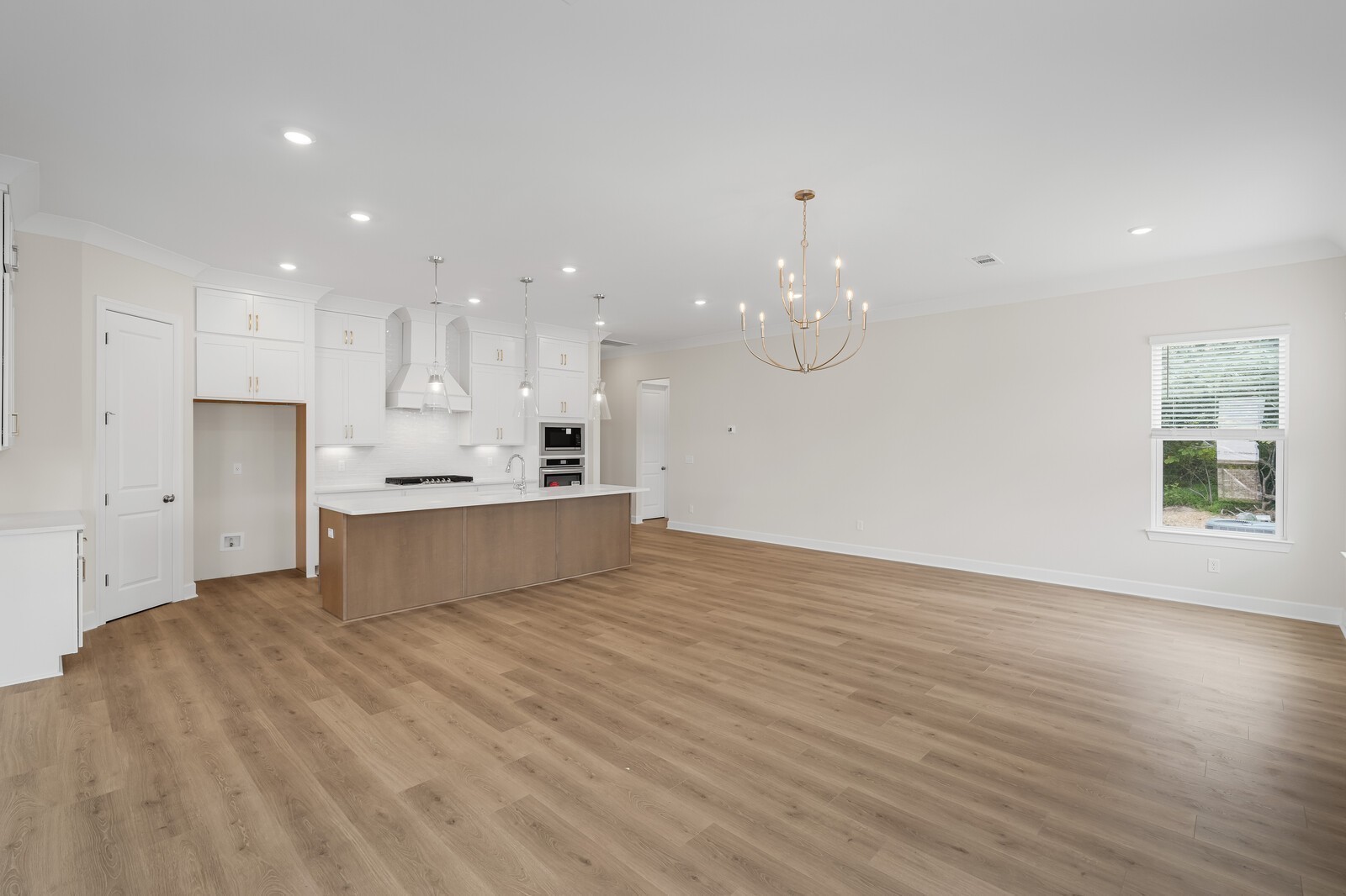 7456 Atwater Circle Fairview, TN 37062 - Photo 21 of 49 a large kitchen with kitchen island a sink dishwasher a stove and a refrigerator with wooden floor