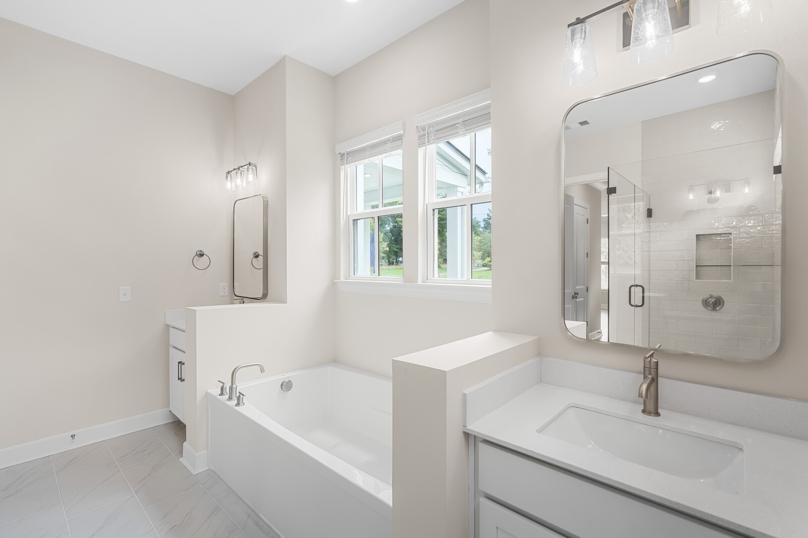 7456 Atwater Circle Fairview, TN 37062 - Photo 28 of 49 a bathroom with a tub sink and mirror