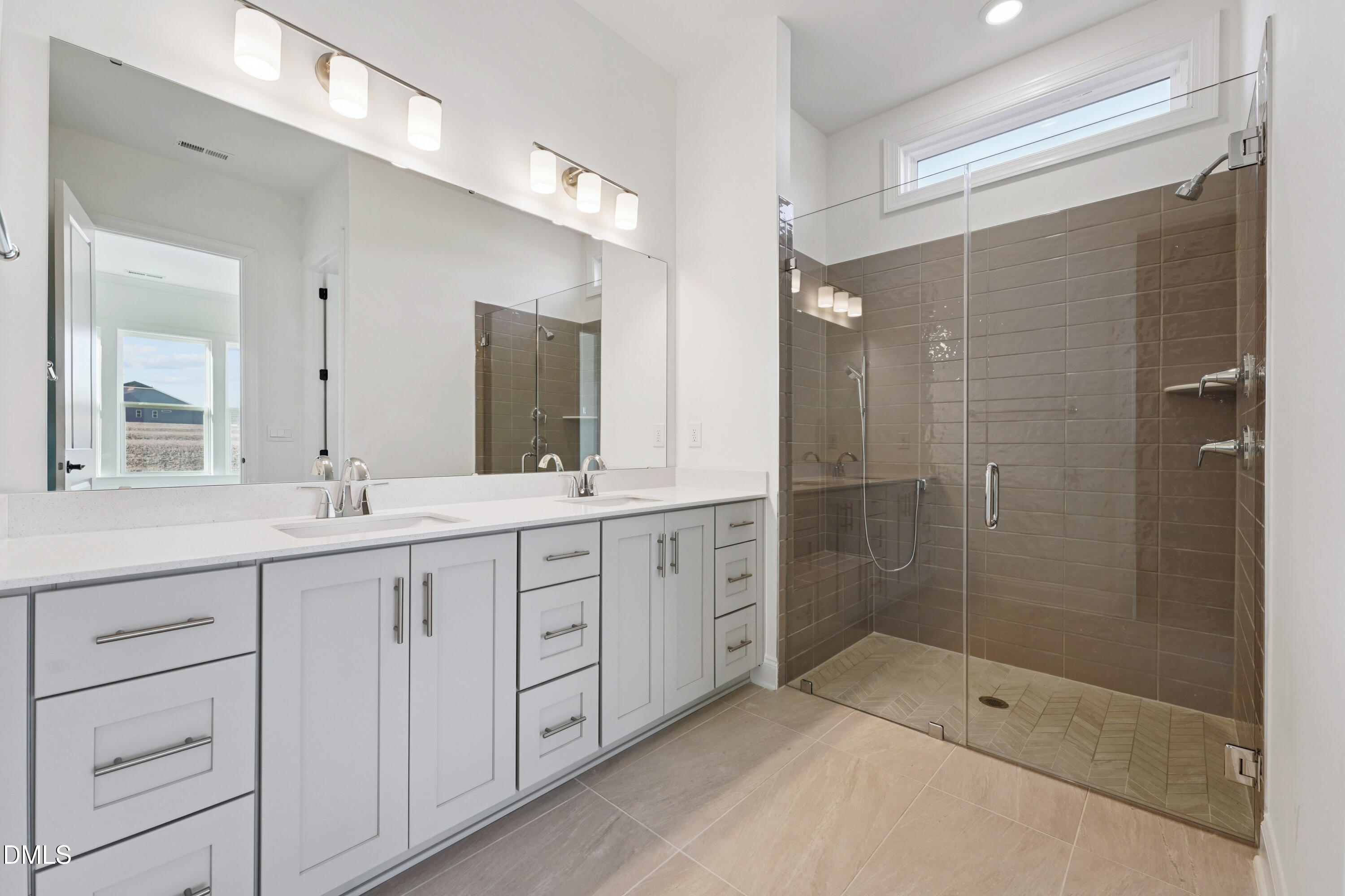 1157 Betula Road, Unit 109 Raleigh, NC 27610 - Photo 11 of 12 a bathroom with a shower sink and mirror