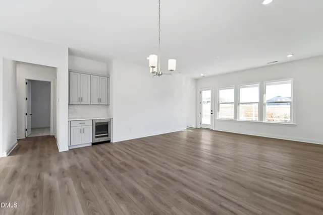 a view of a room with wooden floors and fireplace