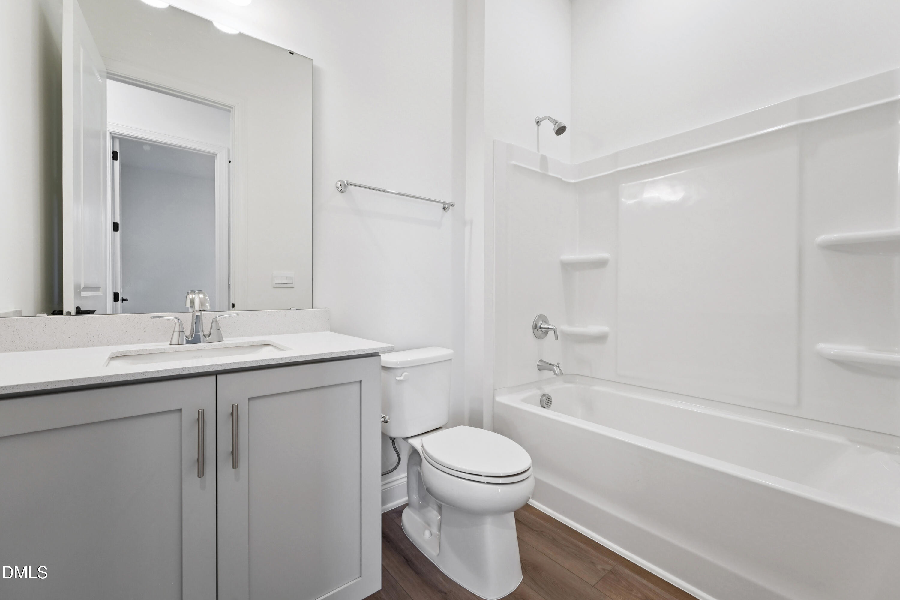 1157 Betula Road, Unit 109 Raleigh, NC 27610 - Photo 9 of 12 a bathroom with a toilet a sink a mirror a bathtub and vanity