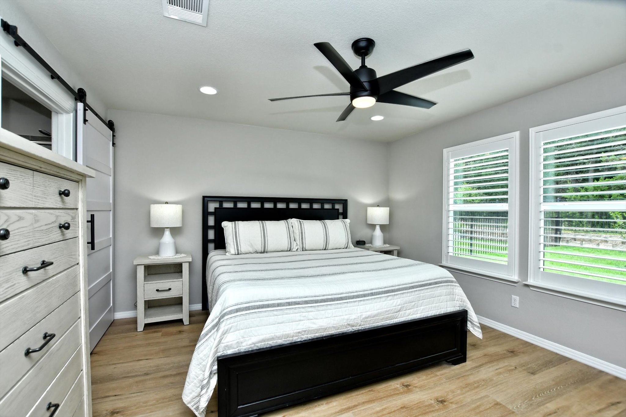 231 Hobby Street Georgetown, TX 78633 - Photo 15 of 29 Comfortable bedroom featuring bright windows and durable wood flooring.