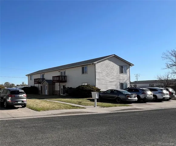 a couple of cars parked in front of a house