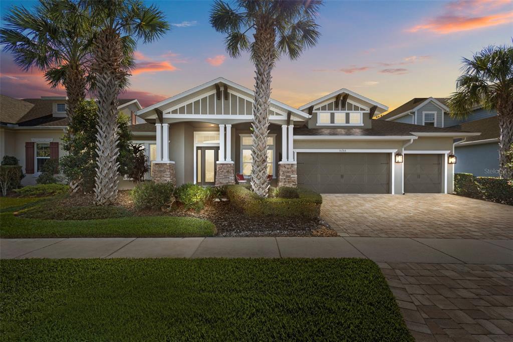 16766 Courtyard Loop Land O Lakes, FL 34638 - Photo 1 of 1 a front view of a house with a garden