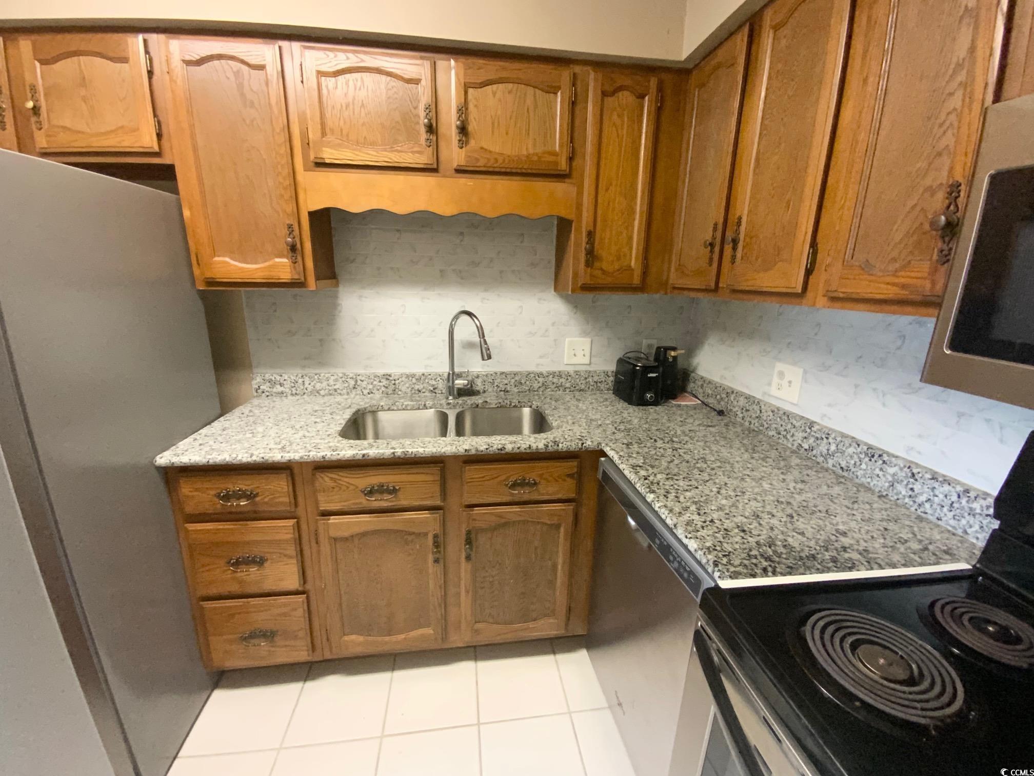 55 Freedom Way, Unit 55 Myrtle Beach, SC 29577 - Photo 3 of 9 Kitchen with light tile patterned flooring, light