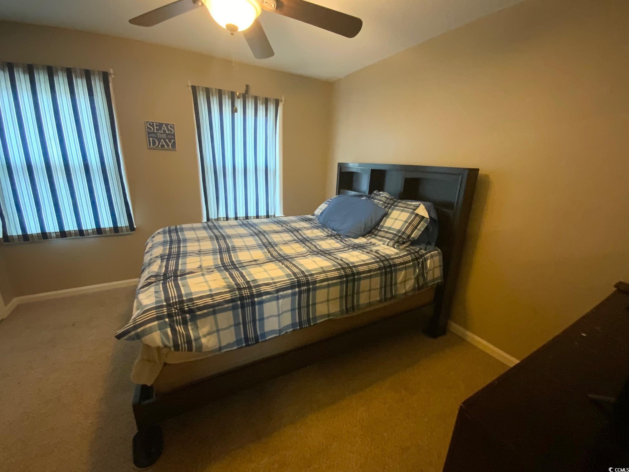 55 Freedom Way, Unit 55 Myrtle Beach, SC 29577 - Photo 6 of 9 Bedroom featuring carpet flooring and ceiling fan