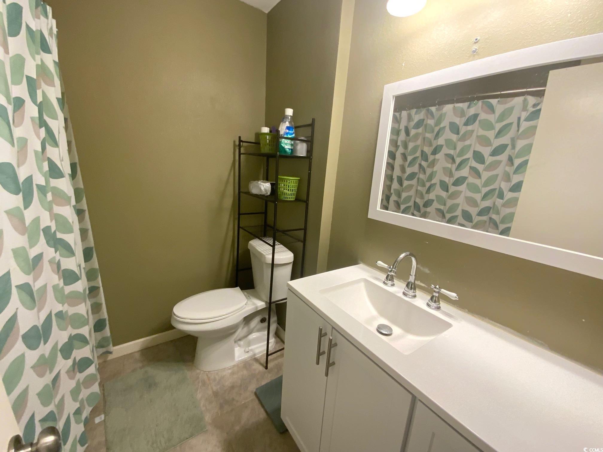 55 Freedom Way, Unit 55 Myrtle Beach, SC 29577 - Photo 7 of 9 Bathroom with curtained shower, vanity, and toilet