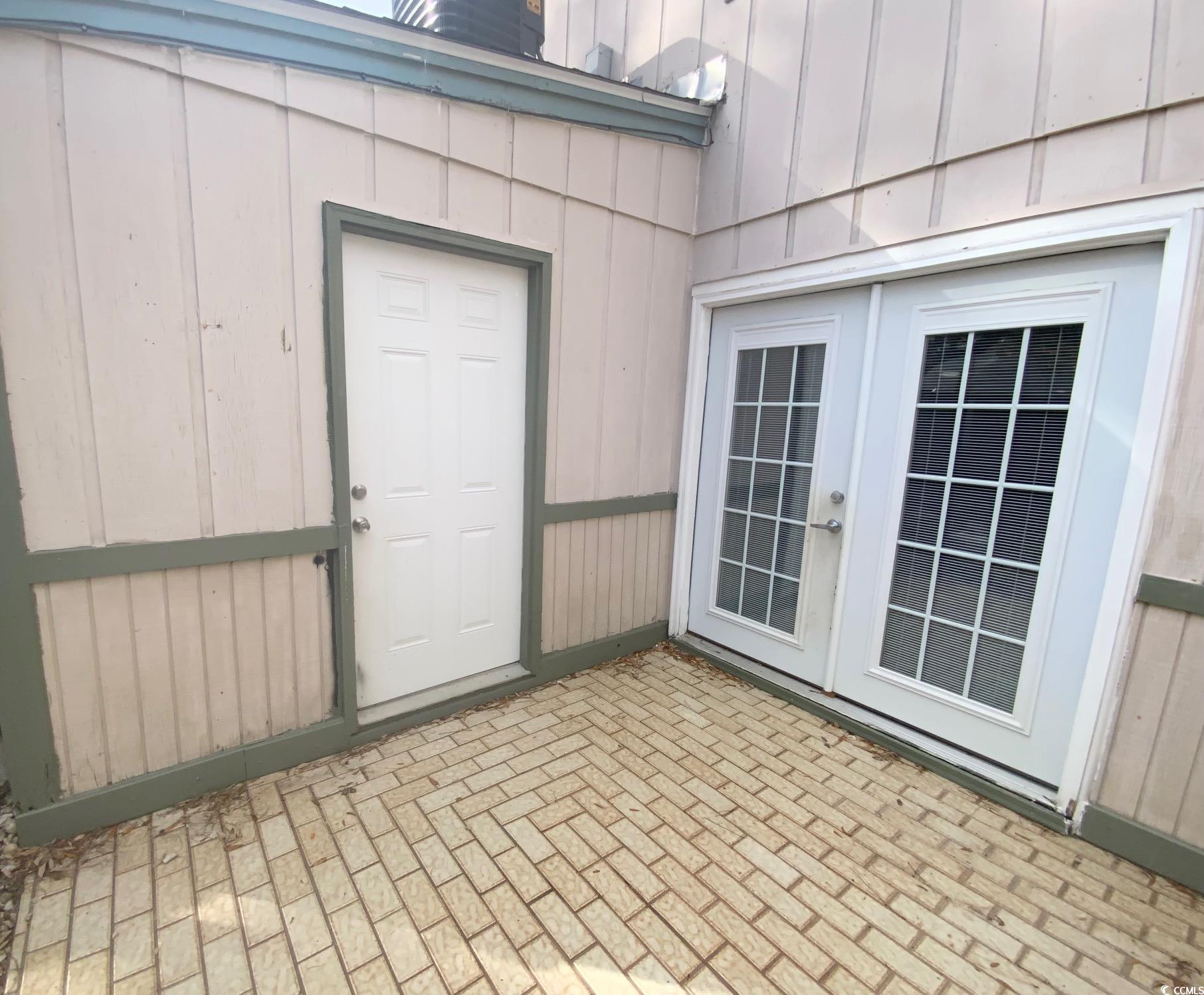 55 Freedom Way, Unit 55 Myrtle Beach, SC 29577 - Photo 8 of 9 View of exterior entry with french doors and a pat