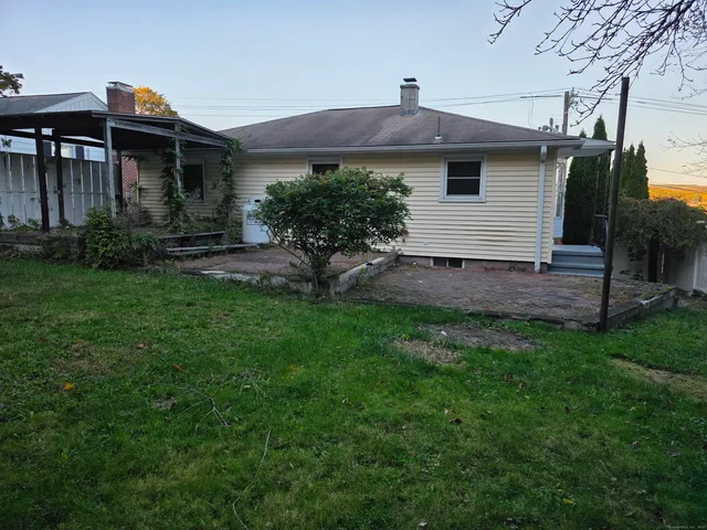 a front view of a house with a garden and plants