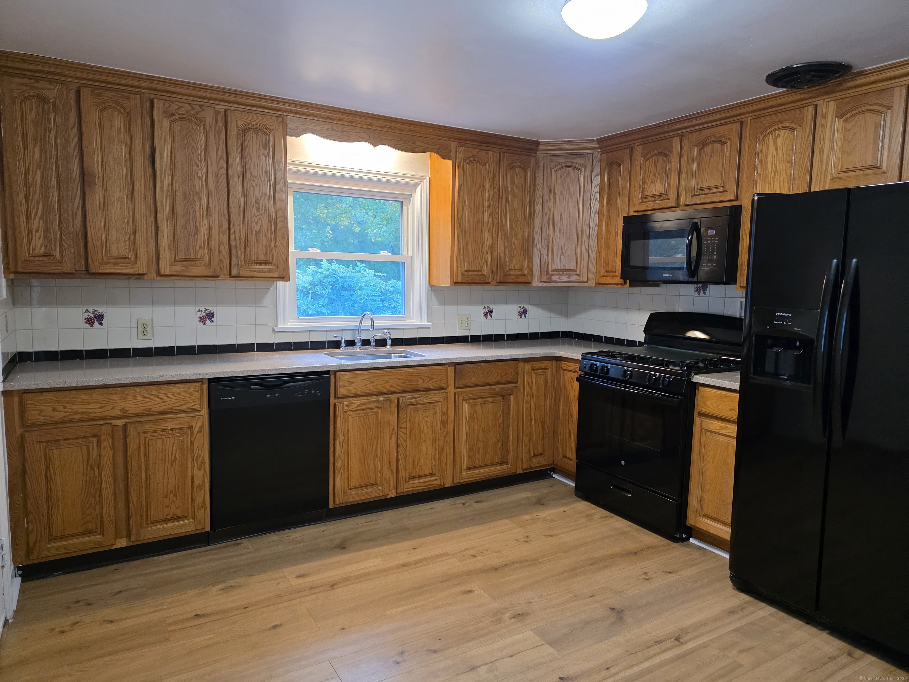 481 Bunker Hill Avenue Waterbury, CT 06708 - Photo 3 of 14 a kitchen with a sink stove top oven and refrigerator