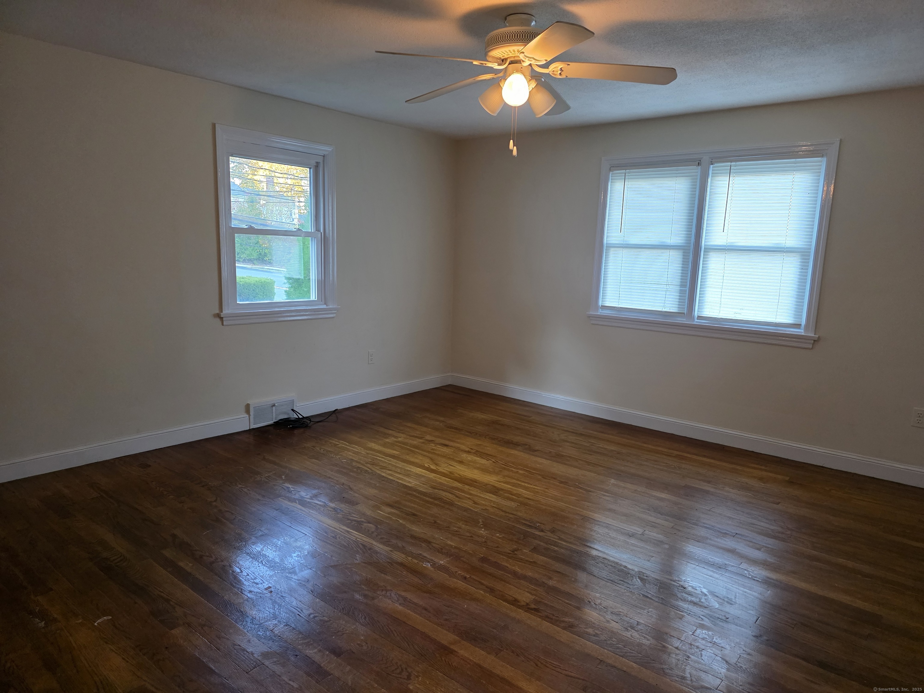481 Bunker Hill Avenue Waterbury, CT 06708 - Photo 4 of 14 a view of an empty room with wooden floor and a window