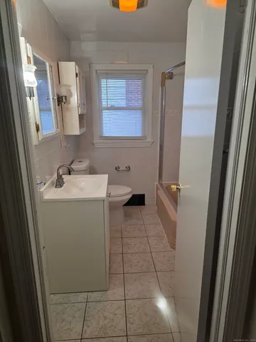 a bathroom with a sink a toilet and mirror