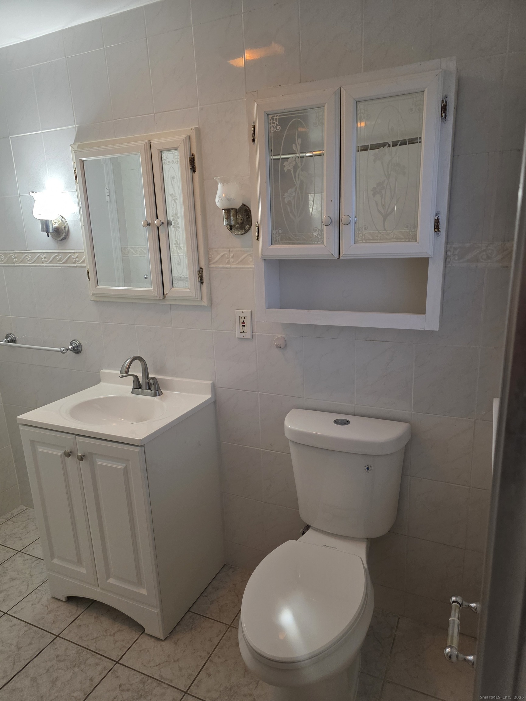 481 Bunker Hill Avenue Waterbury, CT 06708 - Photo 8 of 14 a white toilet sitting next to a bathroom sink