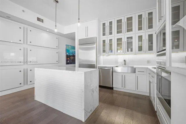 a kitchen with cabinets and stainless steel appliances