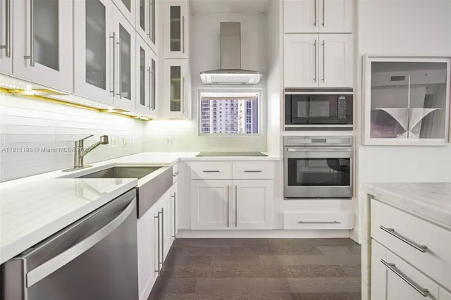 a hallway with wooden floor and a bathroom