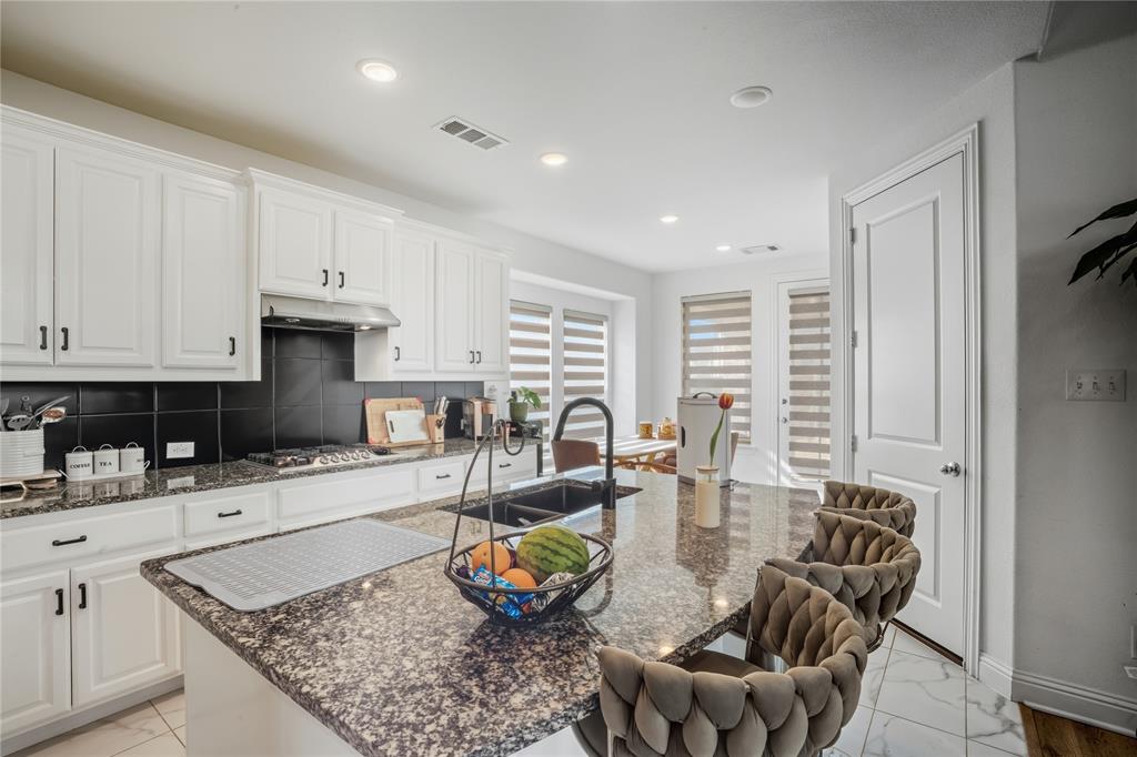 4424 English Maple Drive Arlington, TX 76005 - Photo 12 of 40 a kitchen with stainless steel appliances granite countertop a table chairs in it and a window