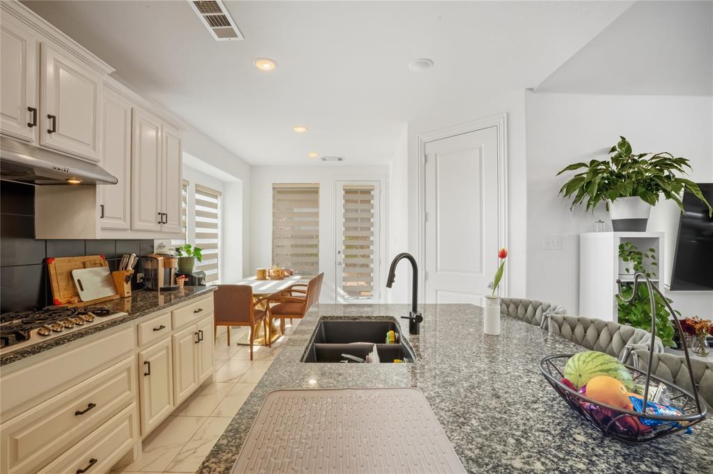 4424 English Maple Drive Arlington, TX 76005 - Photo 15 of 40 a kitchen with sink a stove and cabinets