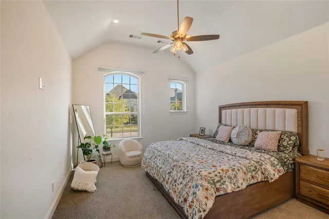 a bedroom with a large bed and a window