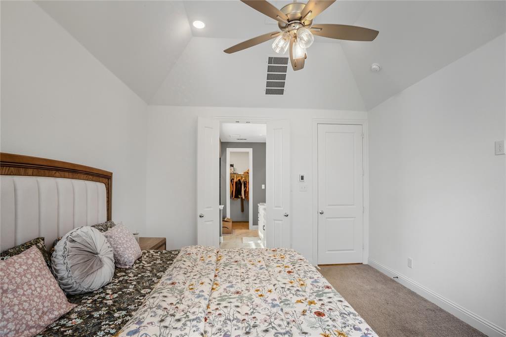 4424 English Maple Drive Arlington, TX 76005 - Photo 20 of 40 a bedroom with a bed and a chandelier