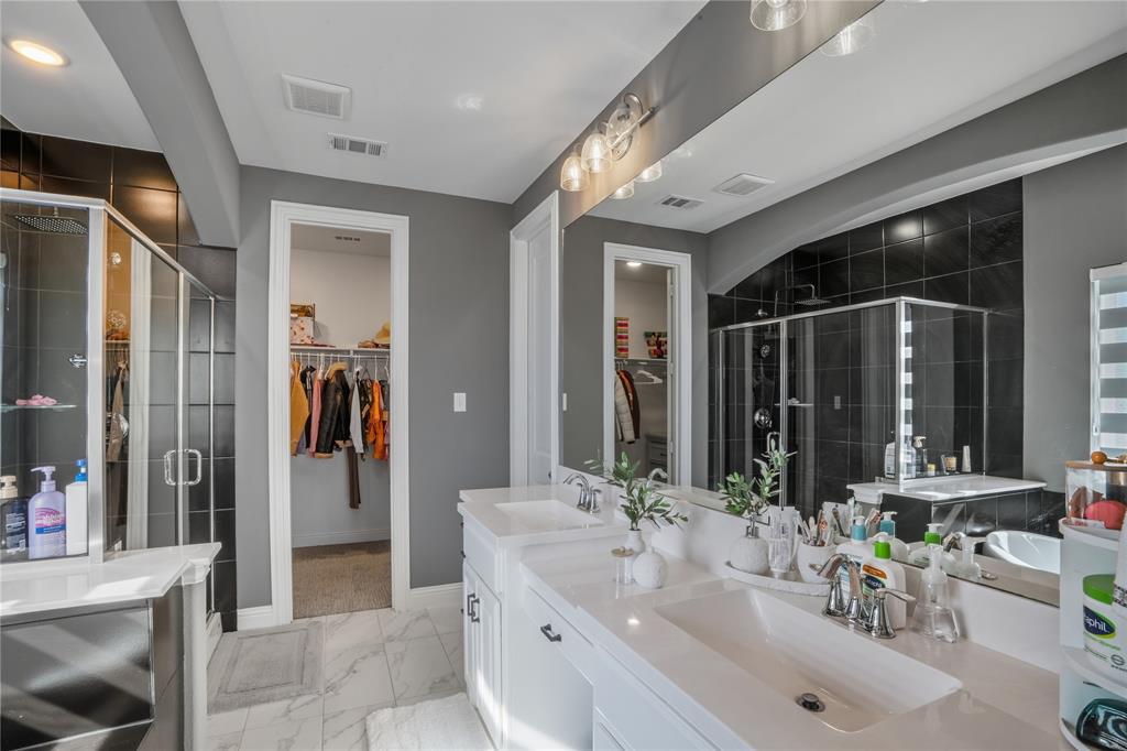 4424 English Maple Drive Arlington, TX 76005 - Photo 21 of 40 a bathroom with double vanity and a shower