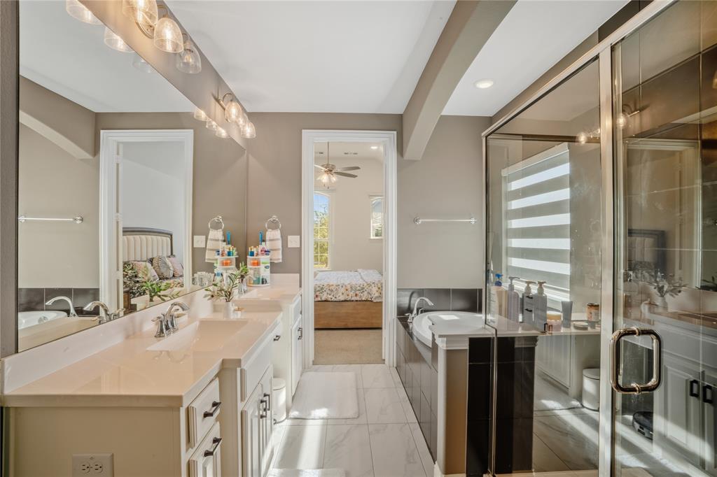 4424 English Maple Drive Arlington, TX 76005 - Photo 22 of 40 a large bathroom with a double vanity sink a mirror and a shower
