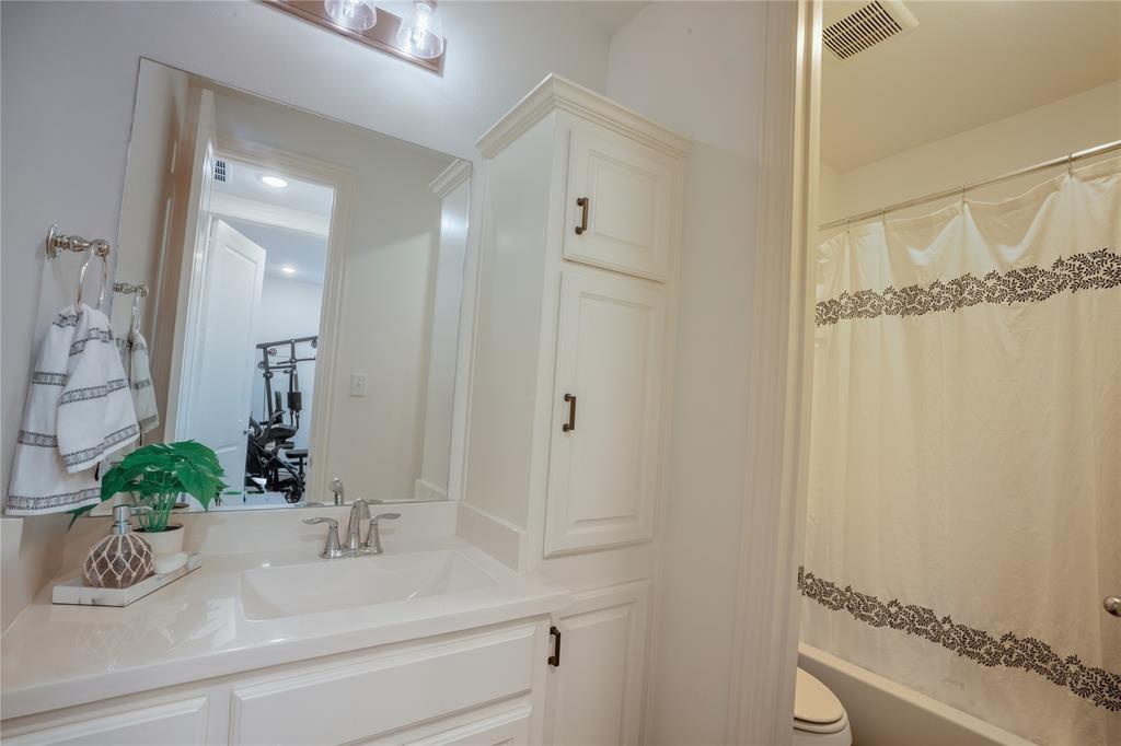 4424 English Maple Drive Arlington, TX 76005 - Photo 33 of 40 a bathroom with a granite countertop sink a mirror and shower