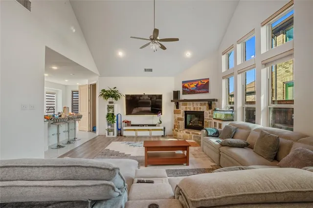 a living room with furniture a fireplace and a flat screen tv