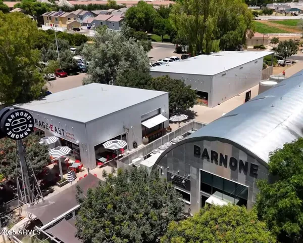 a store with outdoor seating area and blue painted wall