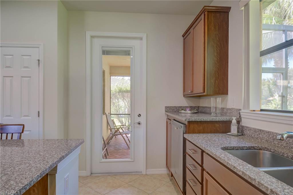 5211 Ciatto Way Ave Maria, FL 34142 - Photo 12 of 31 a kitchen with a granite countertop sink a stove and cabinets
