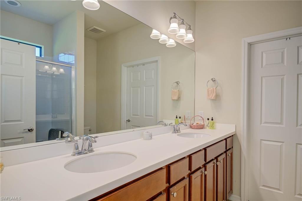 5211 Ciatto Way Ave Maria, FL 34142 - Photo 15 of 31 a bathroom with a sink double vanity and a mirror