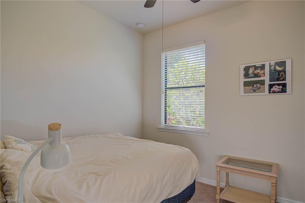 5211 Ciatto Way Ave Maria, FL 34142 - Photo 16 of 31 a bedroom with a bed and a window
