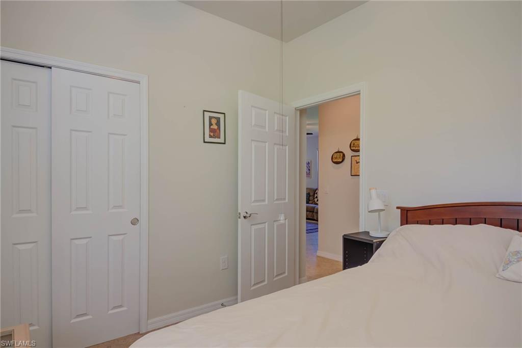 5211 Ciatto Way Ave Maria, FL 34142 - Photo 17 of 31 a bedroom with a bed and a view of bathroom