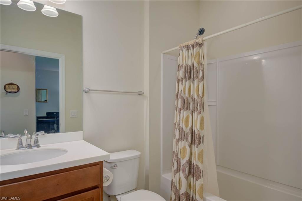 5211 Ciatto Way Ave Maria, FL 34142 - Photo 18 of 31 a bathroom with a sink a toilet and shower