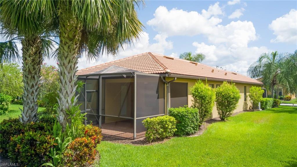 5211 Ciatto Way Ave Maria, FL 34142 - Photo 2 of 31 a view of a house with a yard and plants